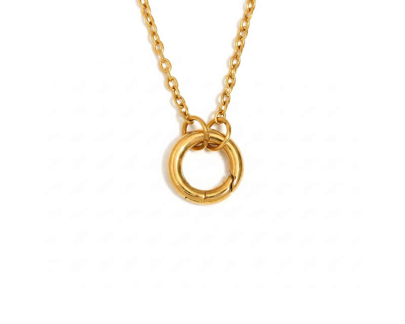 Gold necklace with a circular pendant on a white background