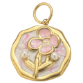 Gold pendant with pink floral design and pearls on a white background